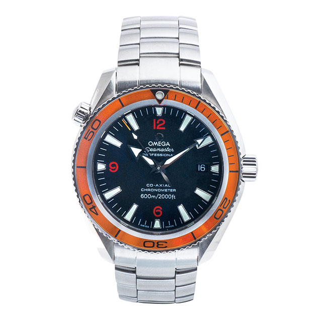 After restoration of pre-owned Omega Seamaster in stainless steel with a black dial and orange bezel.