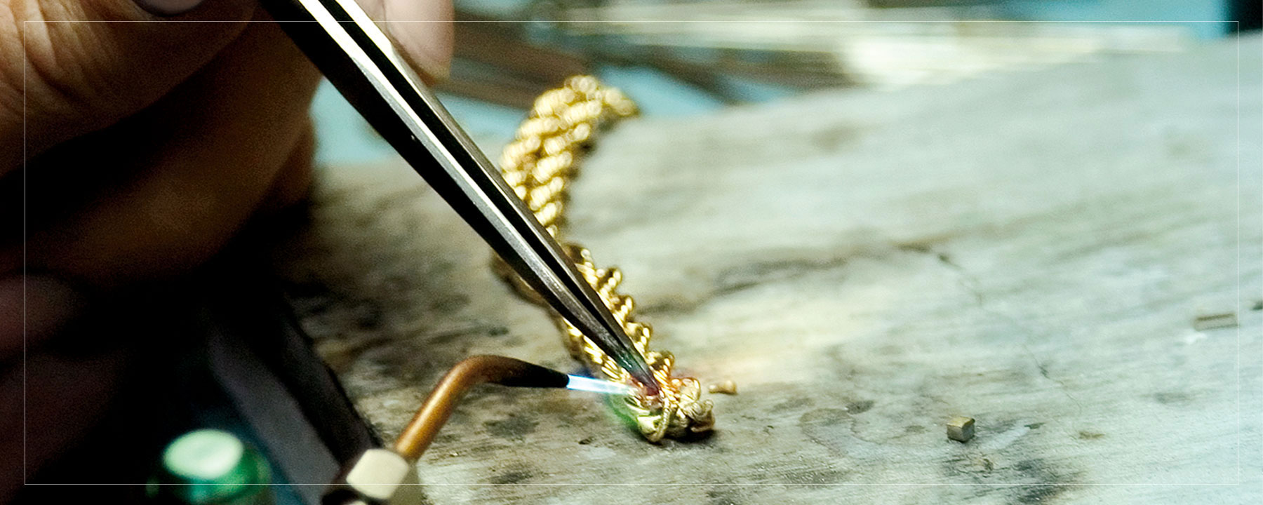 Jeweler repairing yellow gold rope chain.