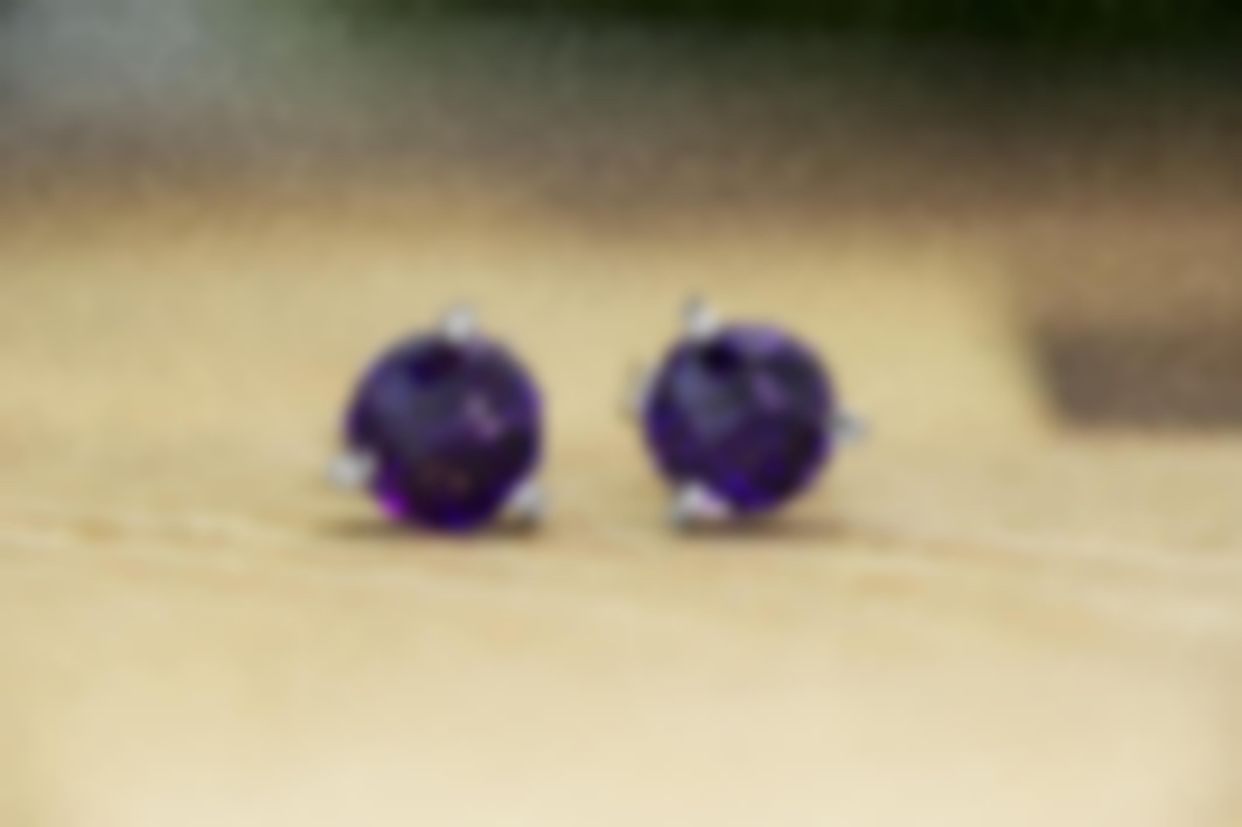 White gold stud earrings set with amethyst.