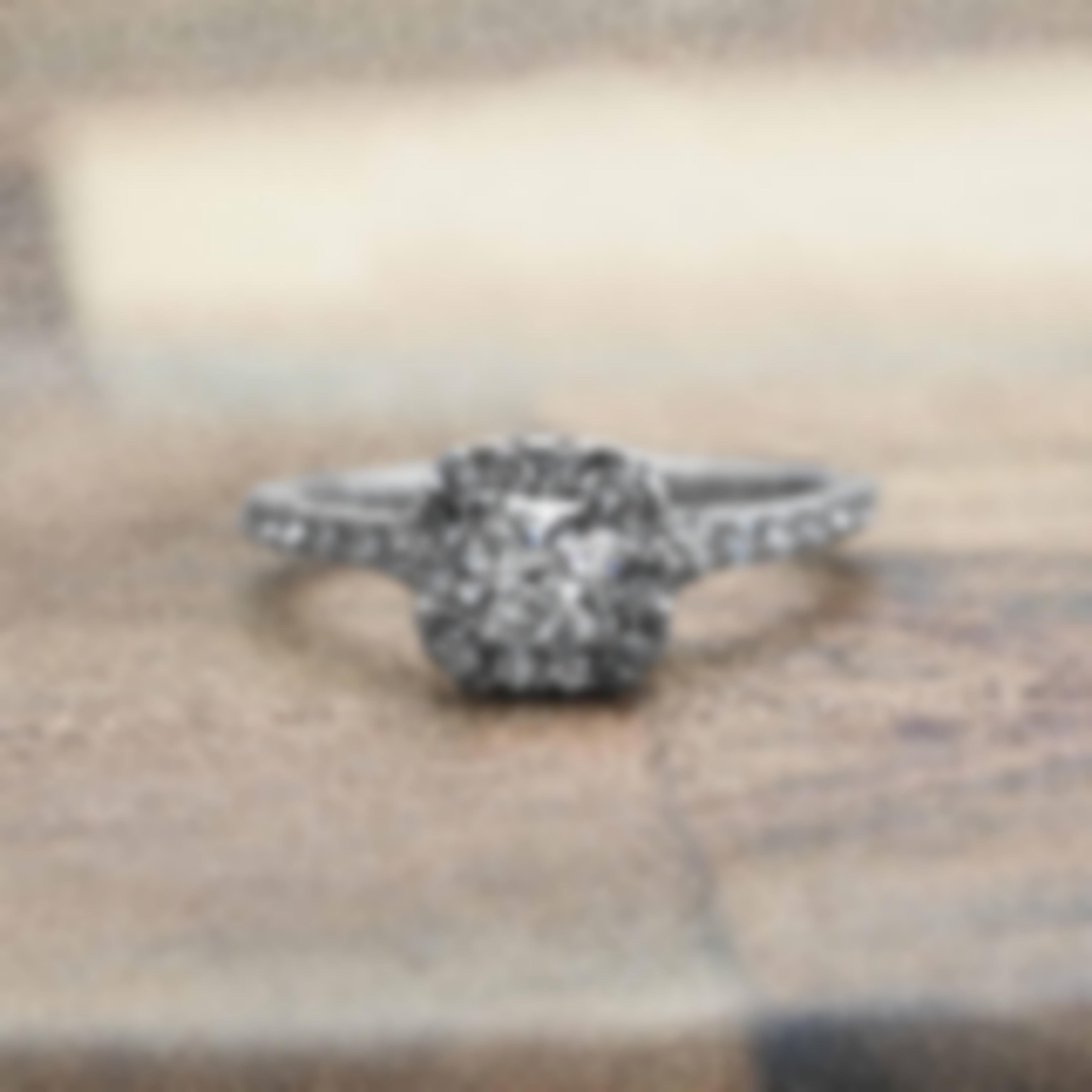 White gold diamond engagement ring with diamond halo and diamonds in the band.