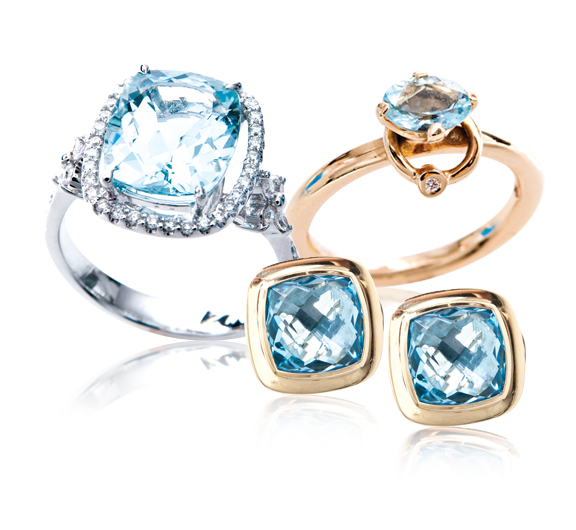 White gold ring, rose gold ring, and yellow gold stud earrings all set with aquamarine.