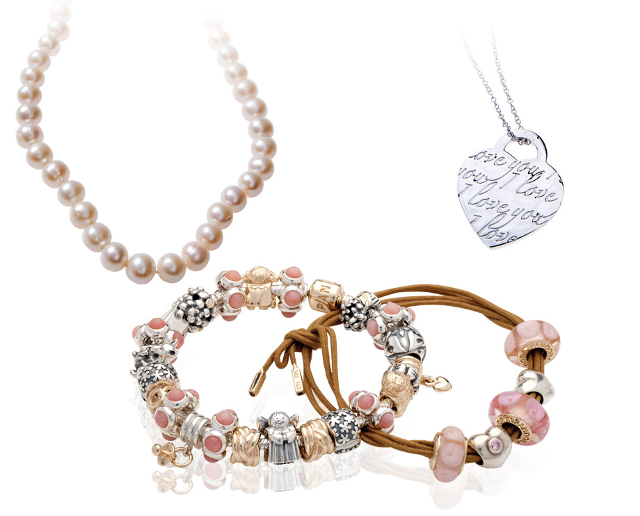 Pandora jewelry including two charm bracelets, and pearl necklace strand, and a heart tag necklace.