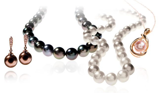 Two pearl strand necklaces, a pair of pearl drop earrings, and one pearl pendant necklace.