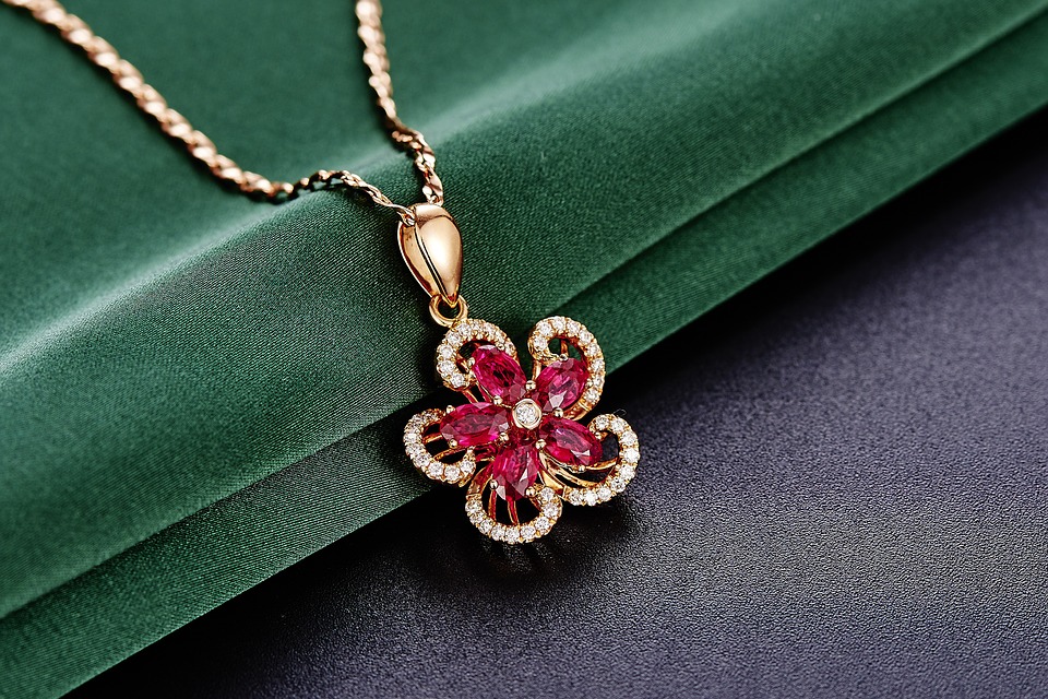 Yellow gold flower necklace set with rubies and diamonds.