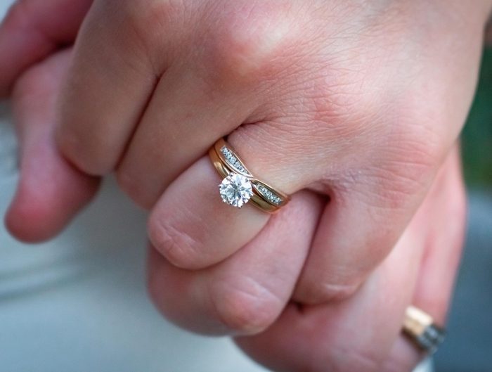 Mixed metal diamond engagement ring with diamonds in the band.