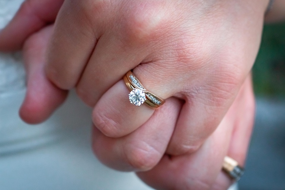 Mixed metal diamond engagement ring with diamonds in the band.