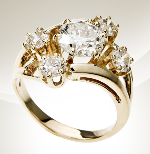 Yellow gold engagement ring centered with a diamond surrounded by four diamond side stones.