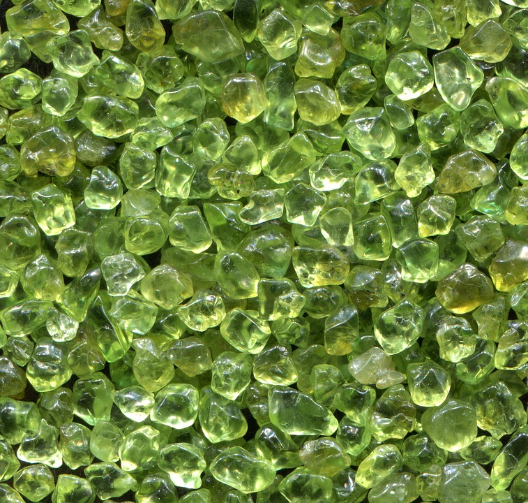 Pile of rough uncut peridot stones.