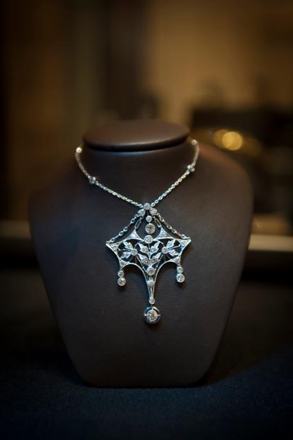 Antique statement necklace on showroom display neck.