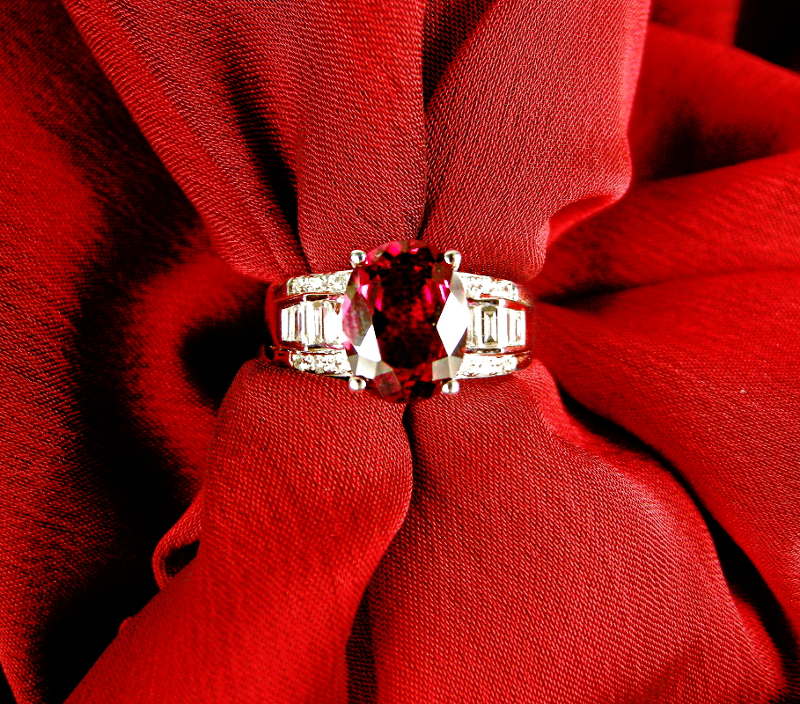 Yellow gold three-row ring centered with a ruby and diamonds in the center band.