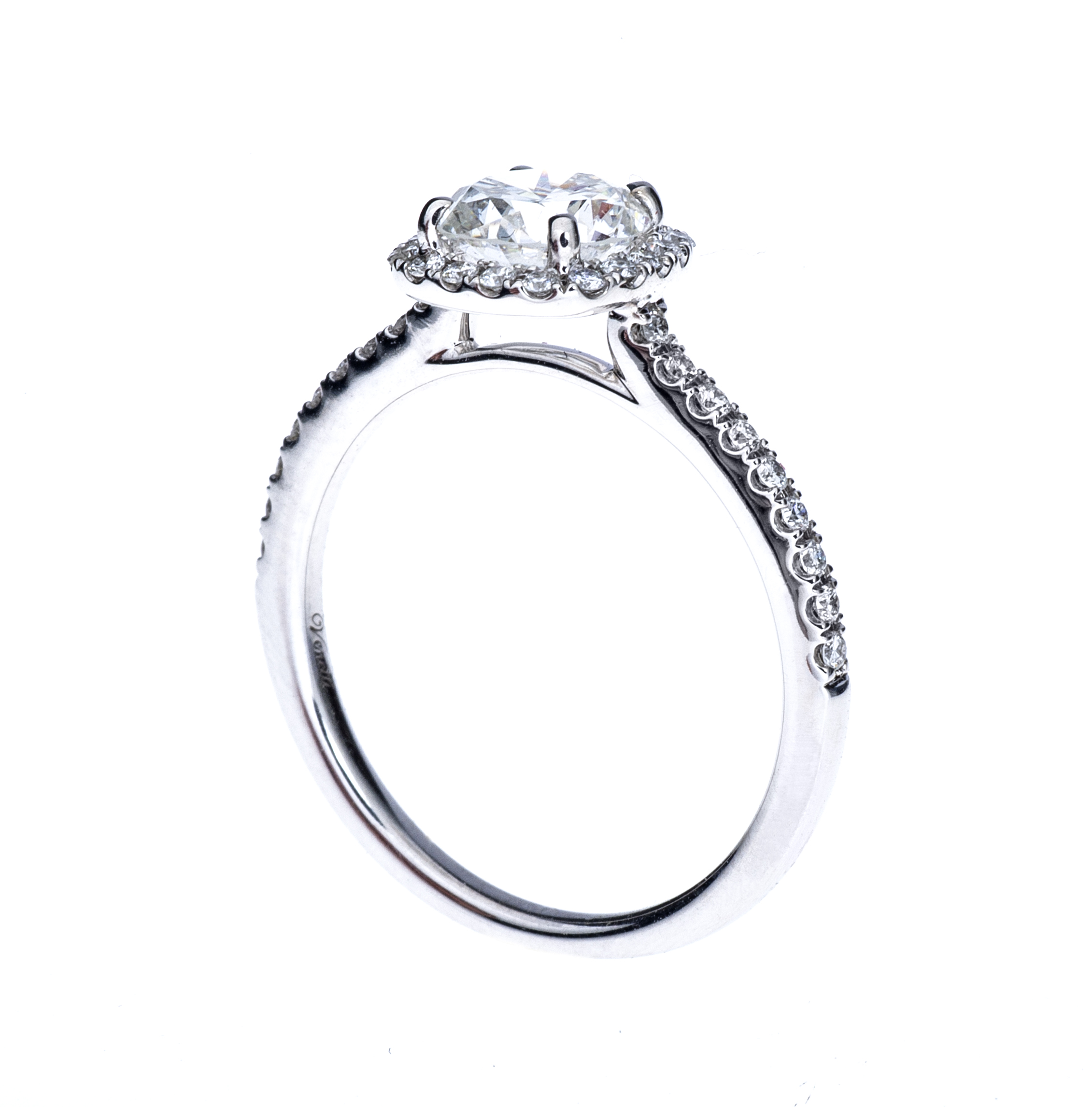 White gold diamond engagement ring with a diamond halo and diamonds in the band.