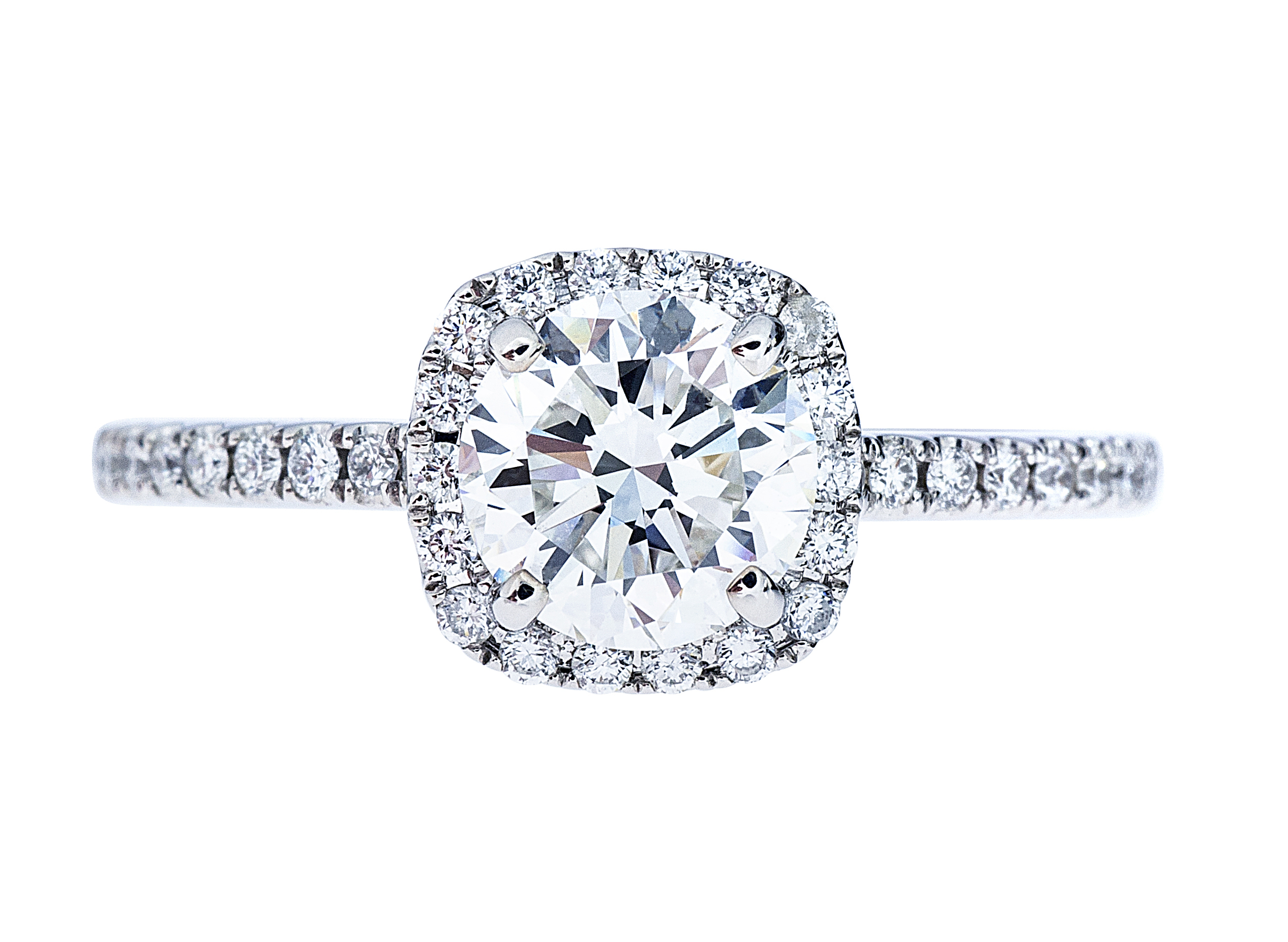 White gold diamond engagement ring with a diamond halo and diamonds in the band.