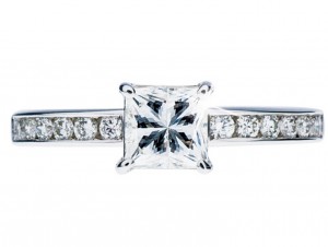 White gold diamond engagement ring with diamonds in the band.