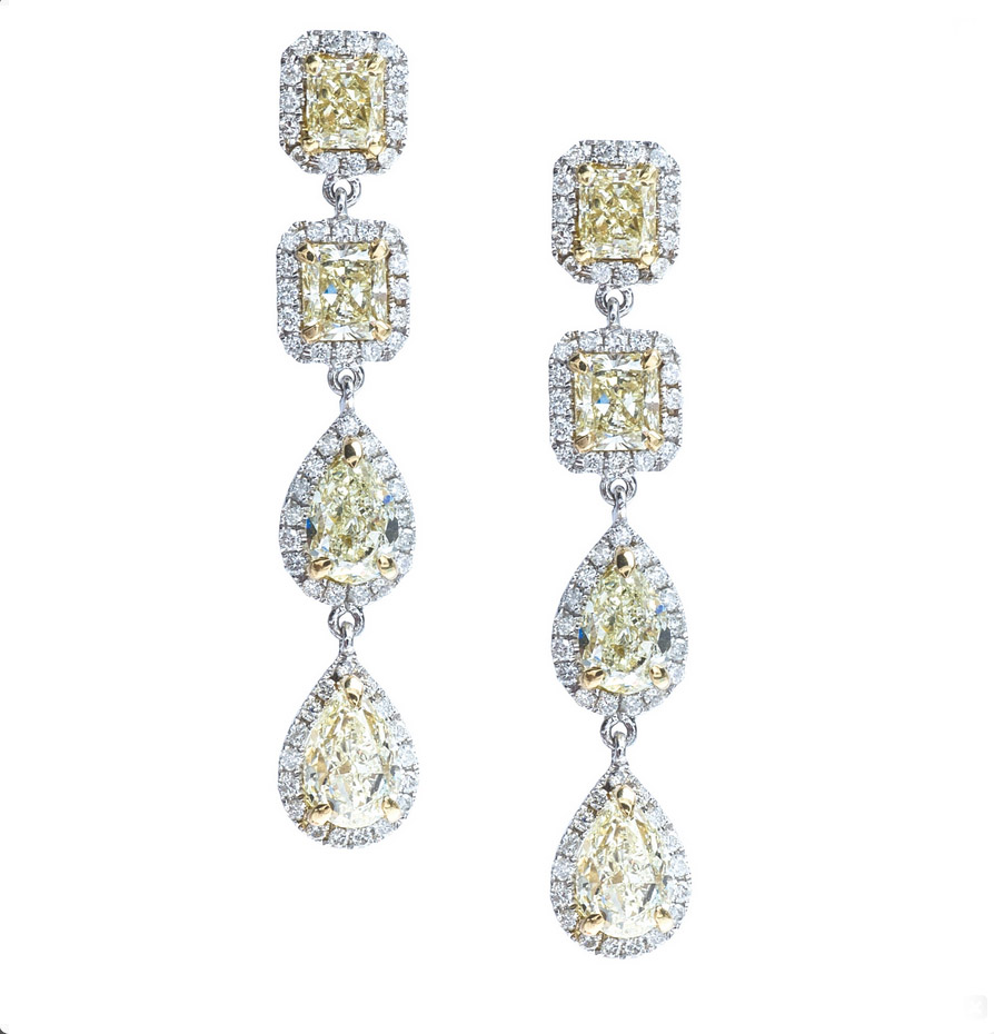 White gold dangle earrings set with yellow and white diamonds.