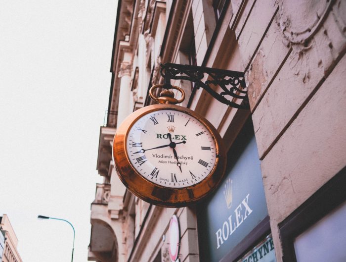 Outside of a retail Rolex store featuring their building Rolex clock.