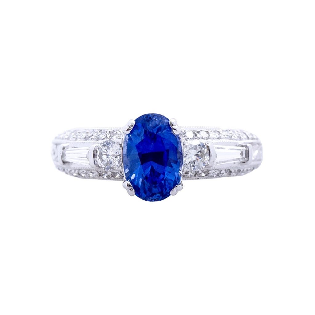 White gold ring centered with a blue sapphire.