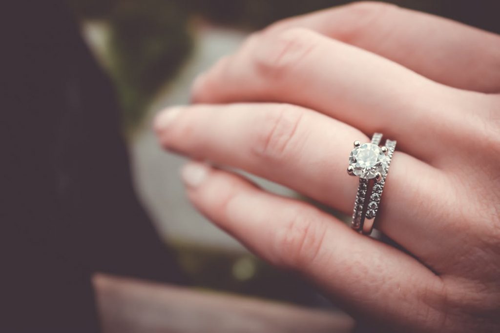 Woman’s hand featuring diamond wedding set.