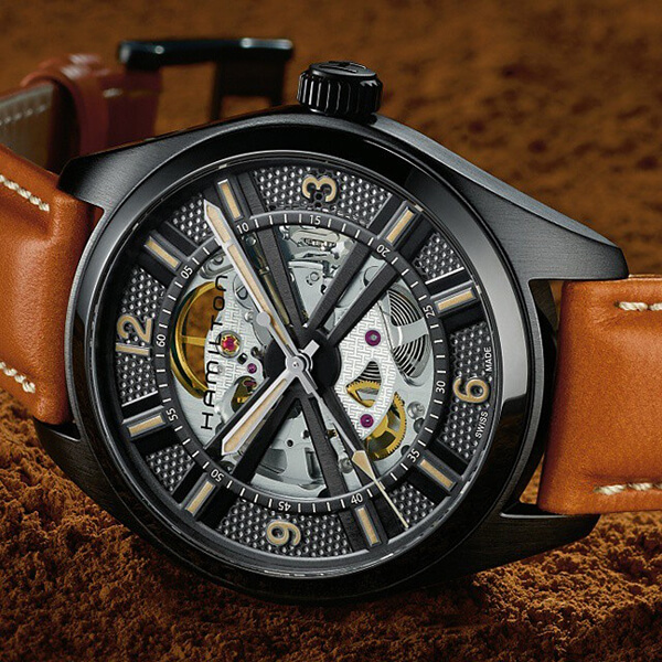 Hamilton skeleton watch in black PVD with a brown leather strap.