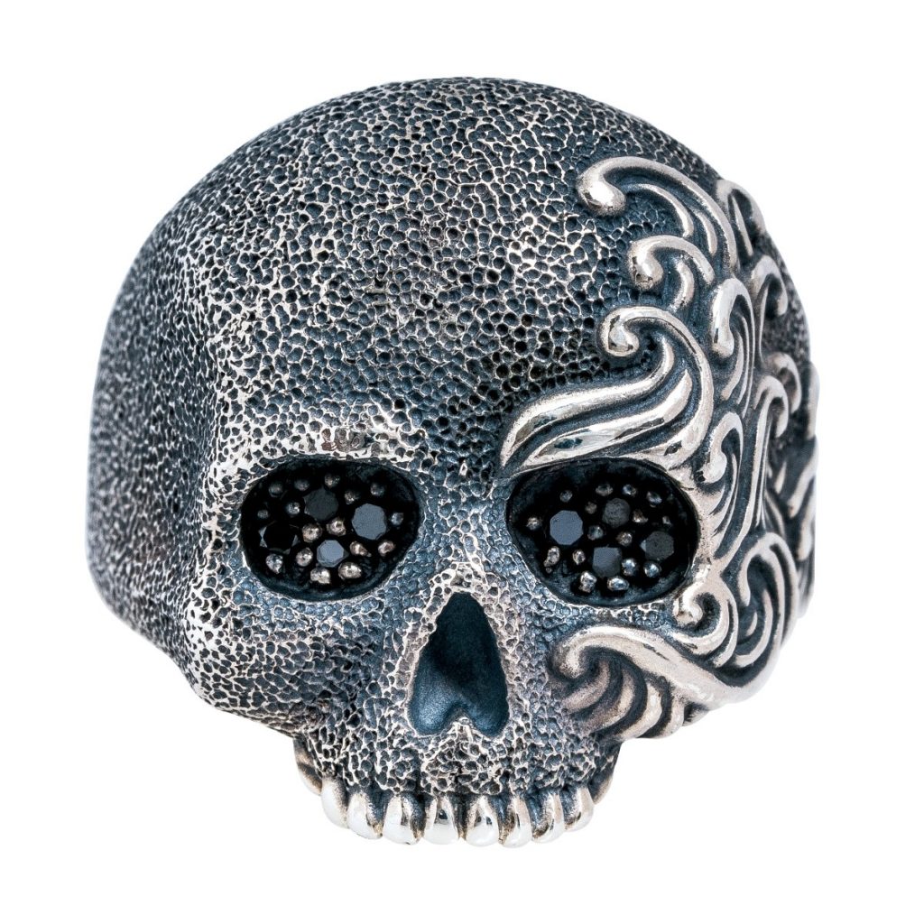 White gold skull ring with black diamond eyes.