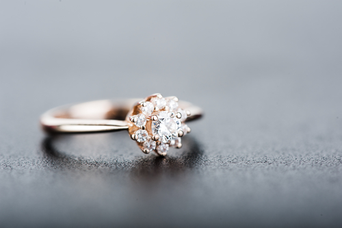 Rose gold diamond engagement ring with diamond halo.