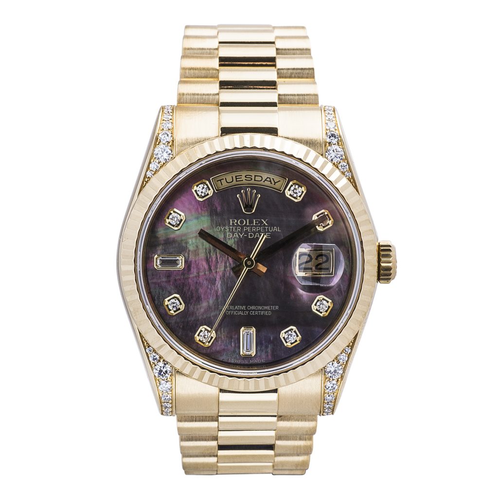 Pre-owned women’s Rolex Day Date in yellow gold with a black mother-of-pearl
diamond dial.