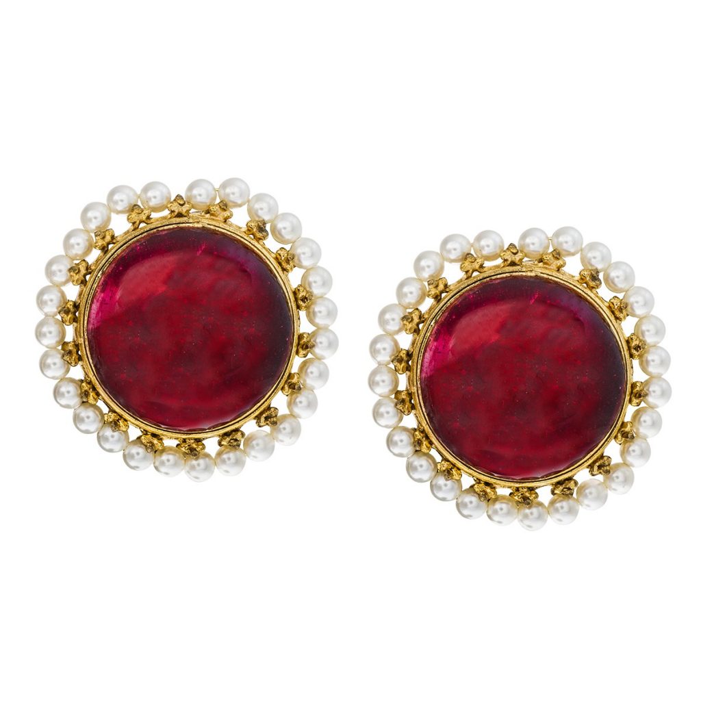 Yellow gold stud earrings set with rubies surrounded by white seed pearl haloes.