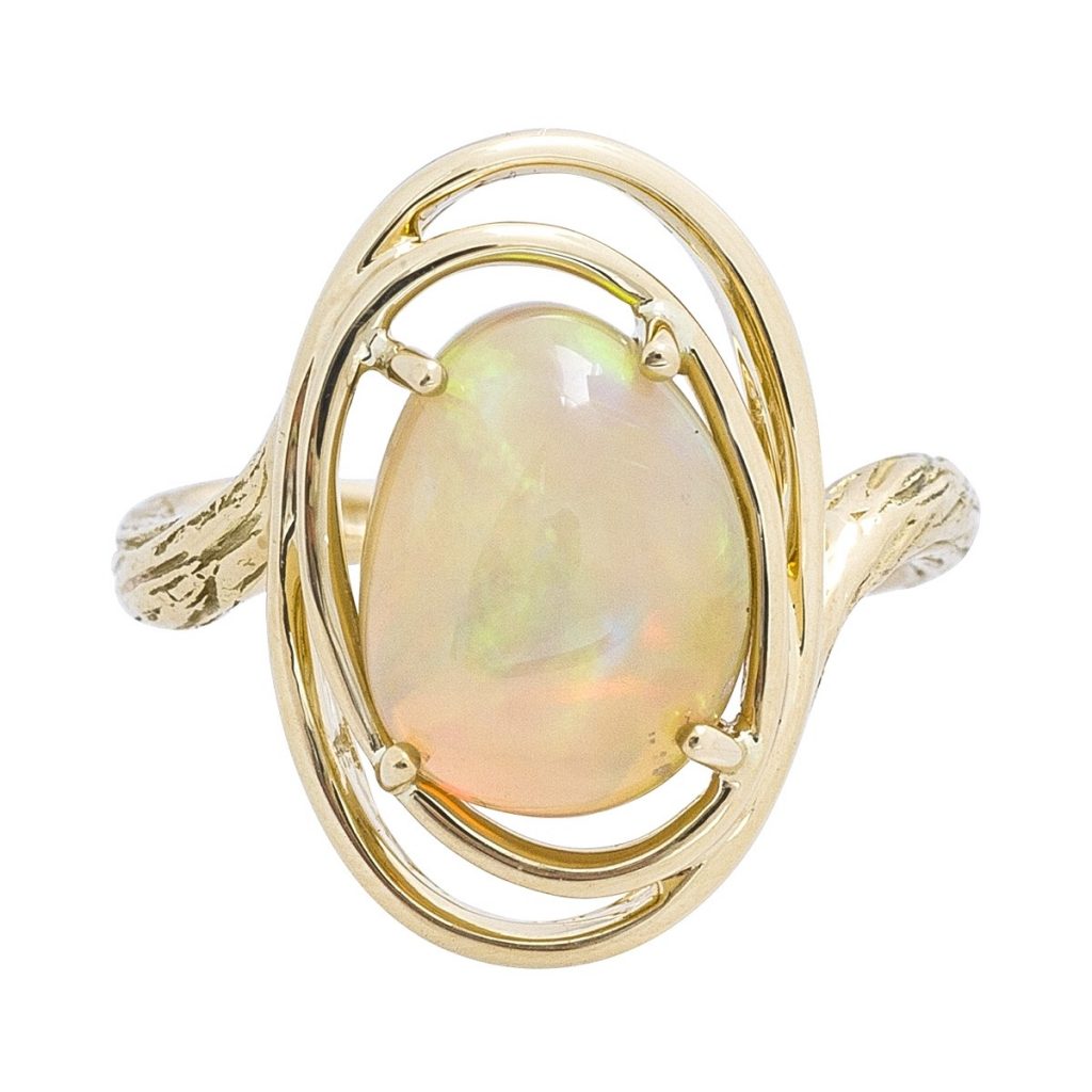 Yellow gold opal ring with swirl band.