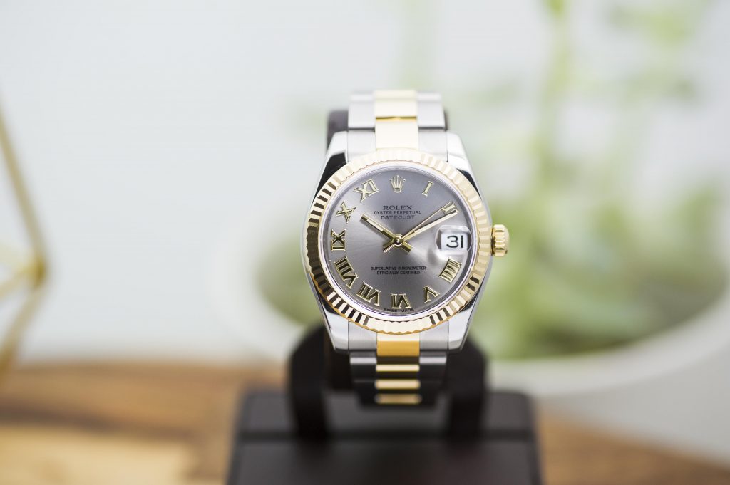 Pre-owned men’s Rolex Datejust in stainless steel and yellow gold with a silver dial and
gold roman numeral markers.