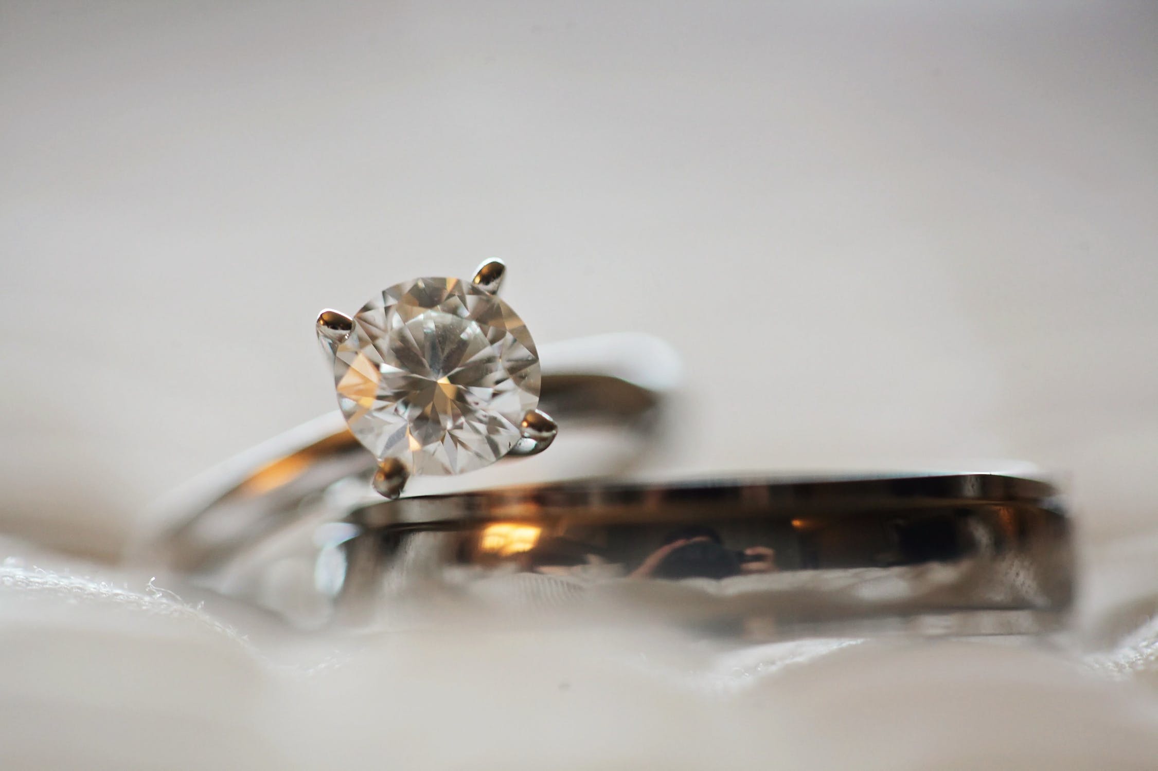 White gold diamond engagement ring stacked with a men’s wedding band.