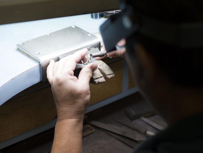 Jeweler working on repair at their bench.