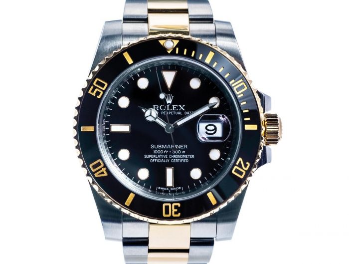 Pre-owned men’s Rolex Submariner in stainless steel and yellow gold with a black dial.