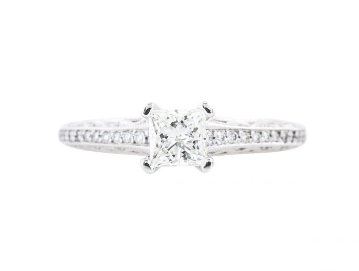 White gold diamond engagement ring with diamonds in the band.
