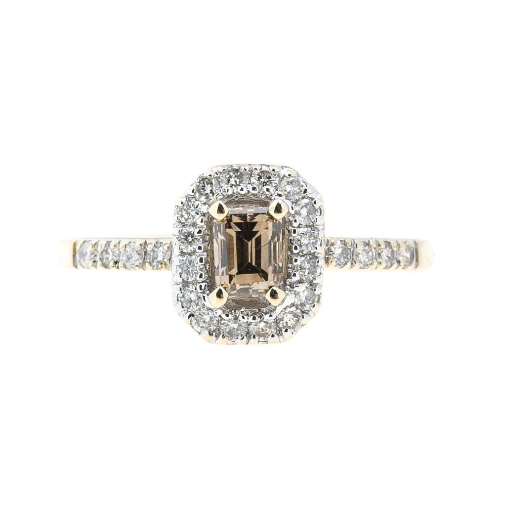 Yellow and white gold engagement ring centered with a light brown diamond surrounded
by a white diamond halo and white diamonds in the band.
