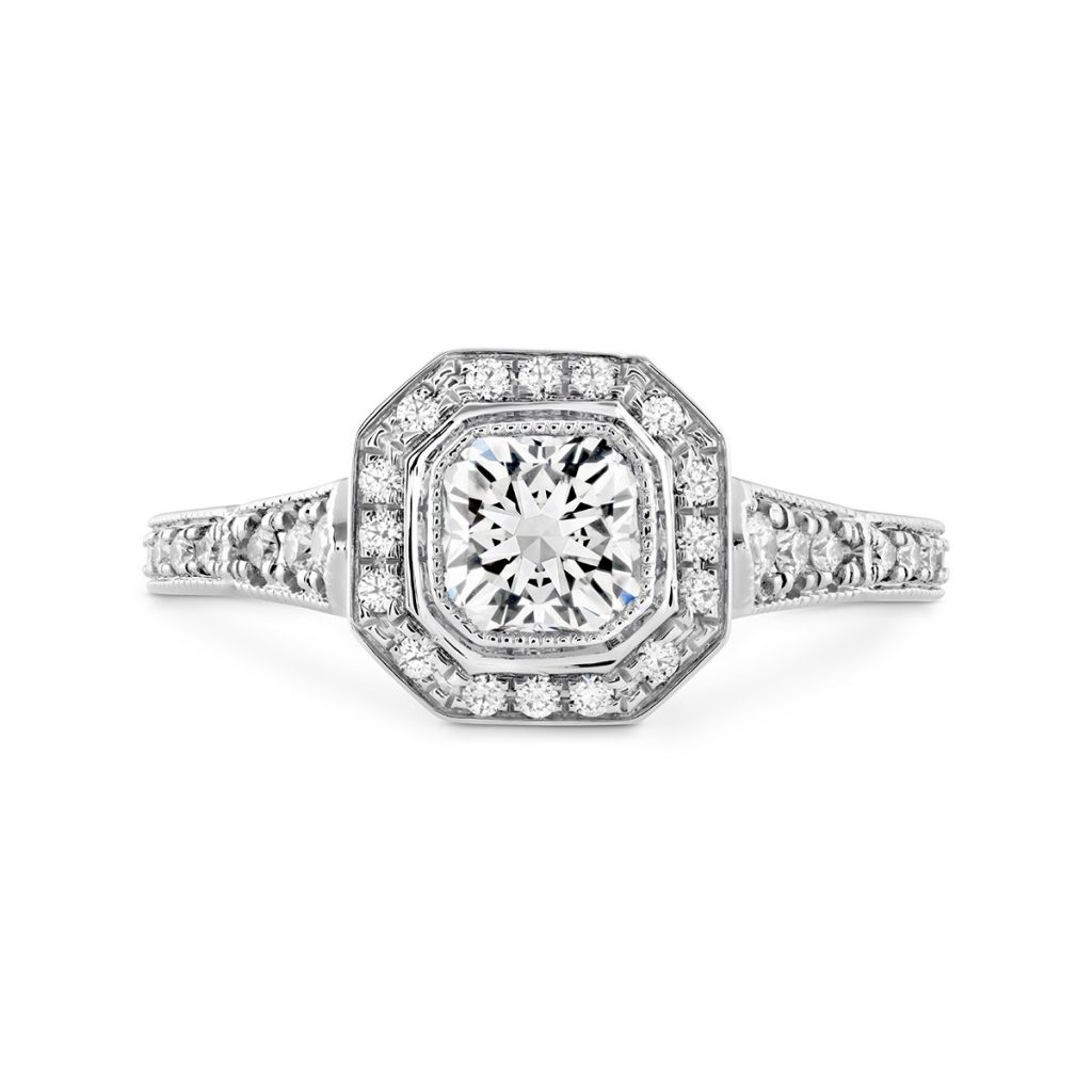 White gold diamond engagement ring with diamond halo and diamonds in the band.