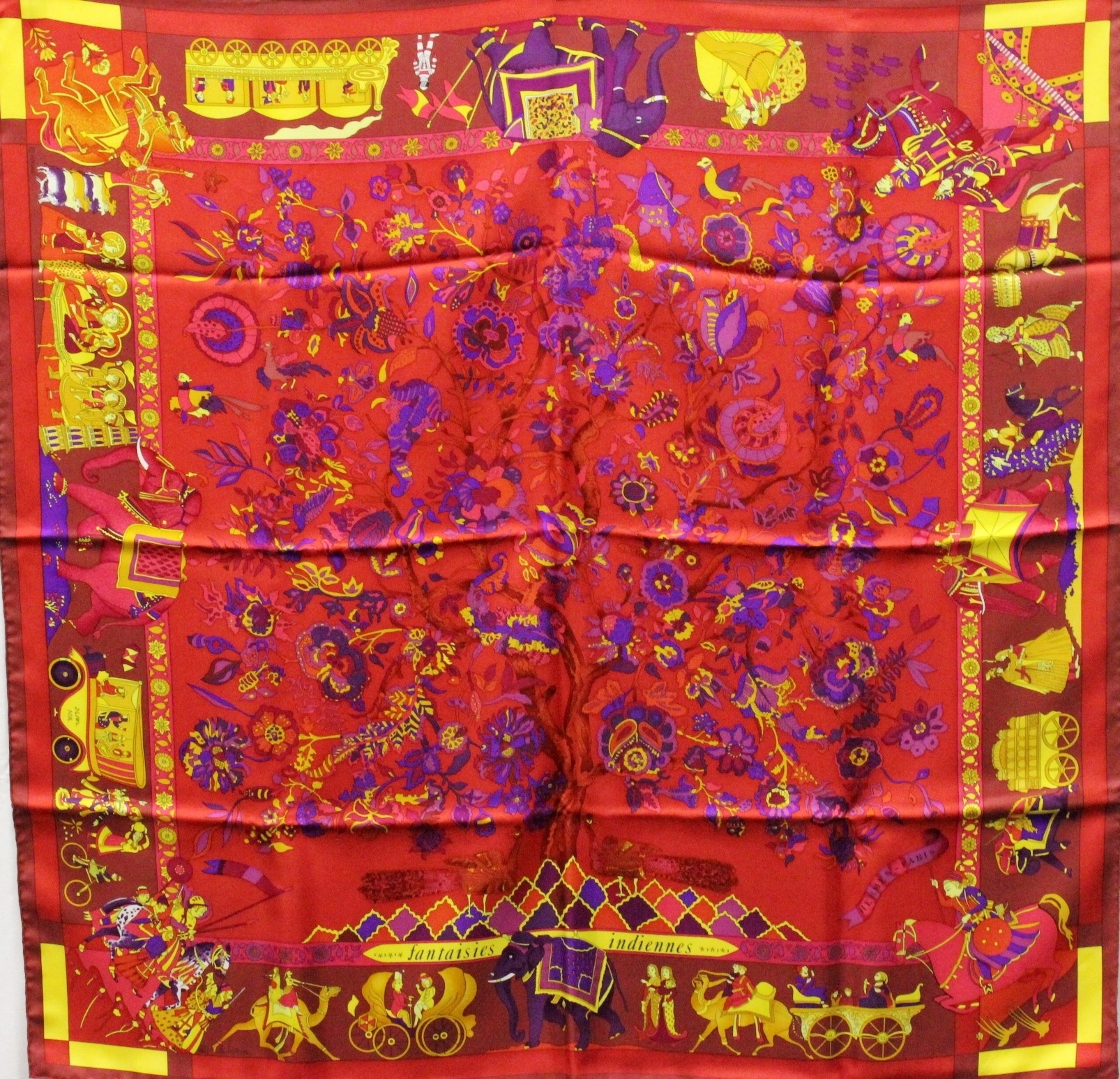 Vintage Hermès scarf in red with African animal border and floral center.