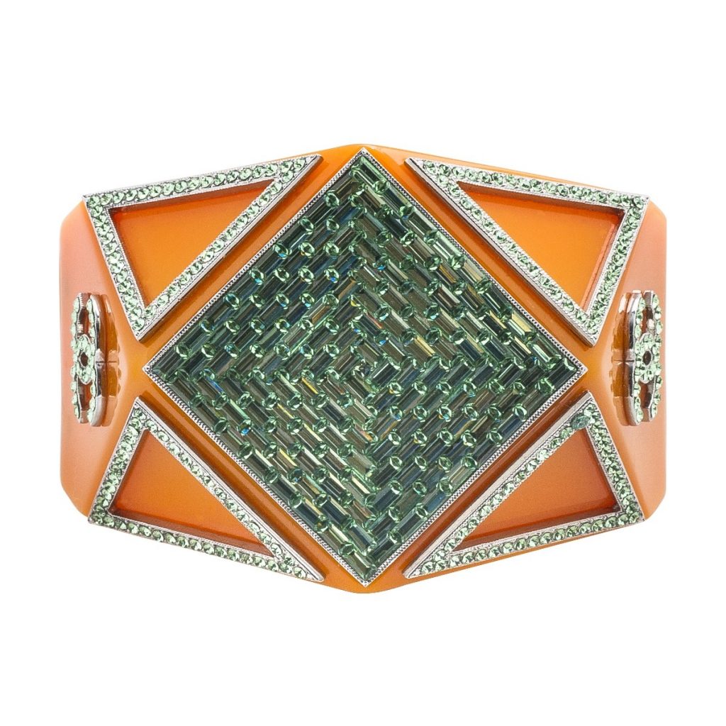 Vintage Chanel magnetic cuff bracelet set with green gemstones and orange enamel.