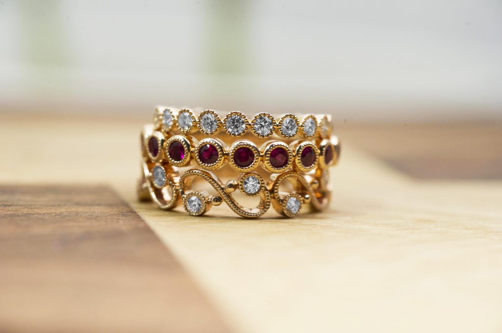 Yellow gold stacking diamond and gemstone eternity rings.