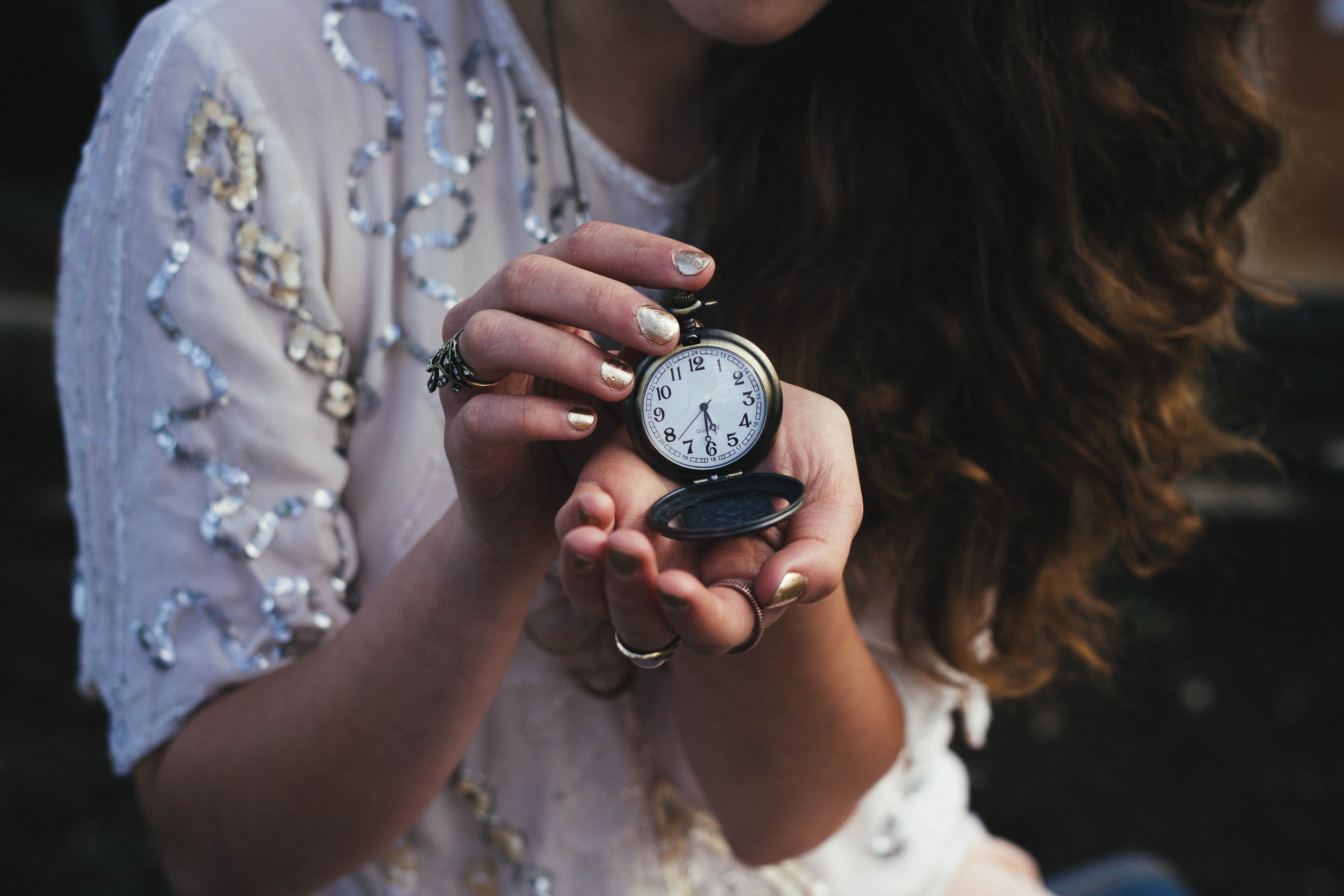 Woman holding up a vintage watch.