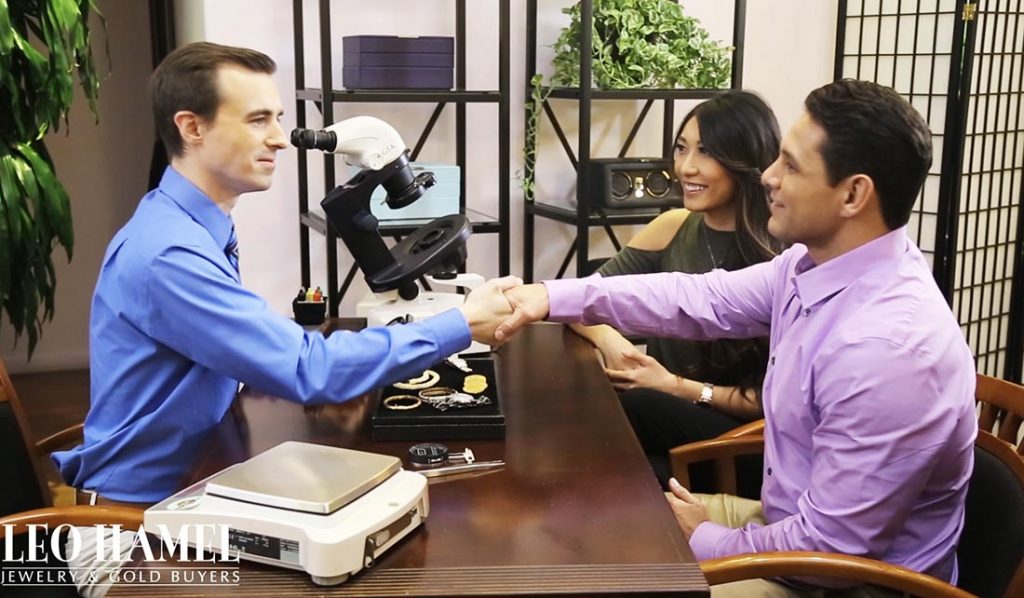 Couple shaking hands with Leo Hamel Gold & Jewelry Buyers staff member in one of
our buying offices.