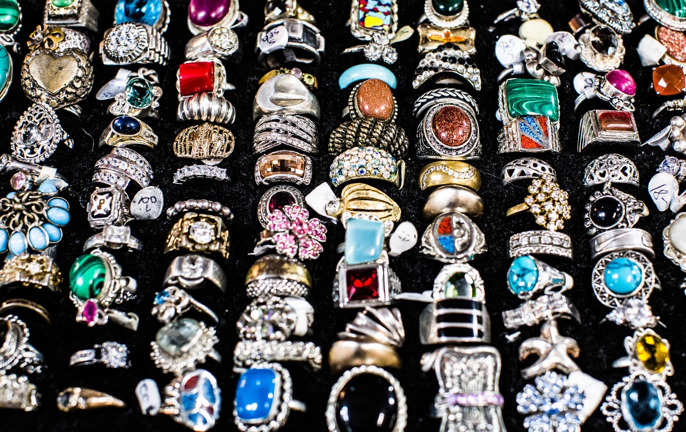 Collection of vintage gemstone rings in ring display box.