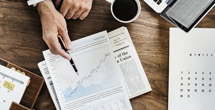 Investment trends paperwork laid out across desk.