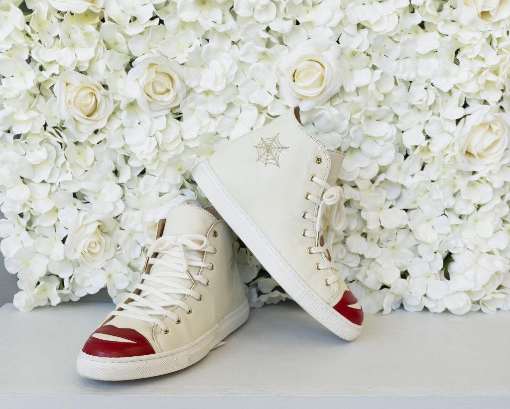 Vintage white high-top sneakers with red lipped toe.