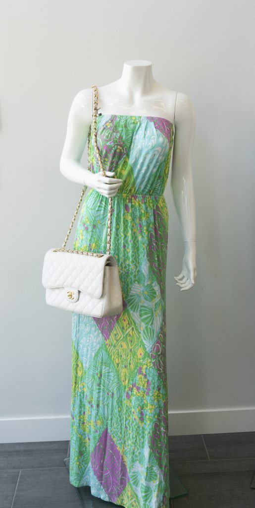 Mannequin with floral sundress and vintage handbag.