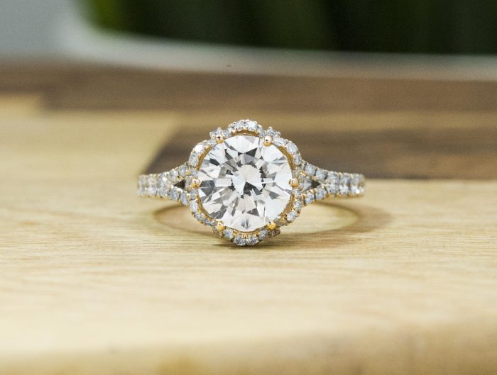 White gold diamond engagement ring with a diamond halo and diamonds in the band.