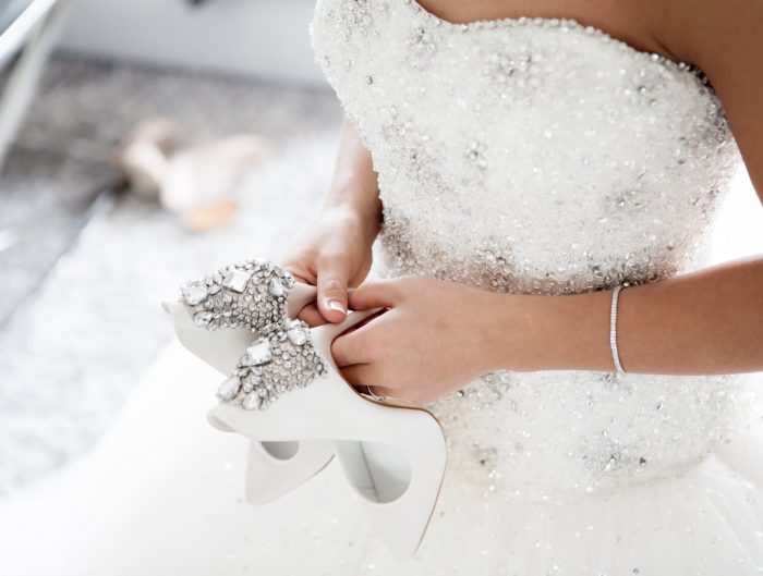 Bride holding diamond high heels.