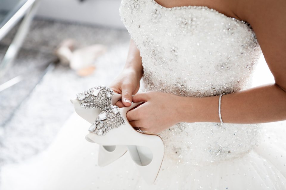 Bride holding diamond high heels.