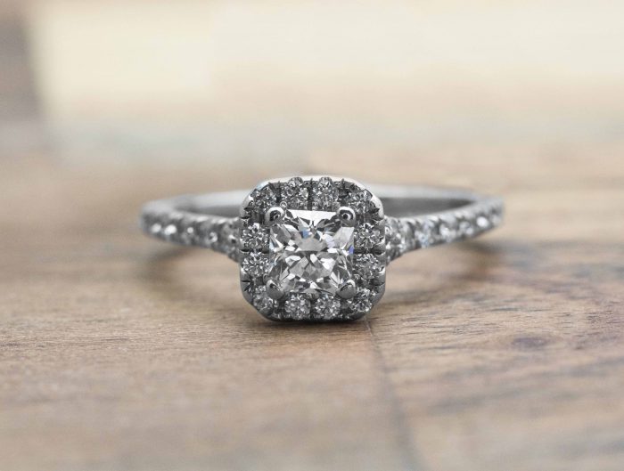 White gold diamond engagement ring with diamond halo and diamonds in the band.