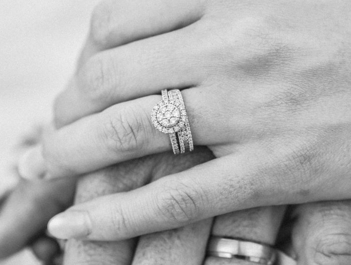 Woman's hand featuring diamond wedding set.