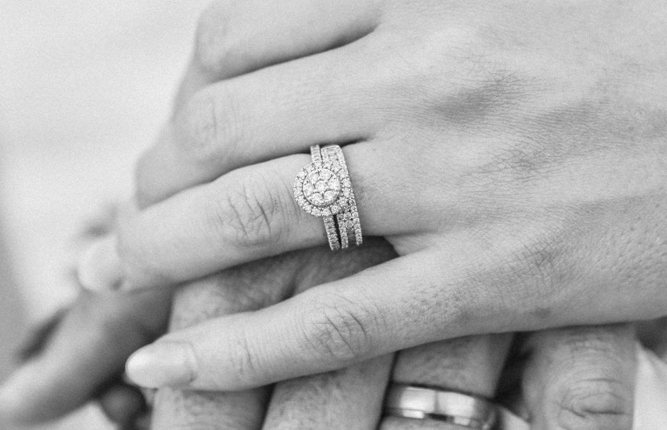 Woman's hand featuring diamond wedding set.