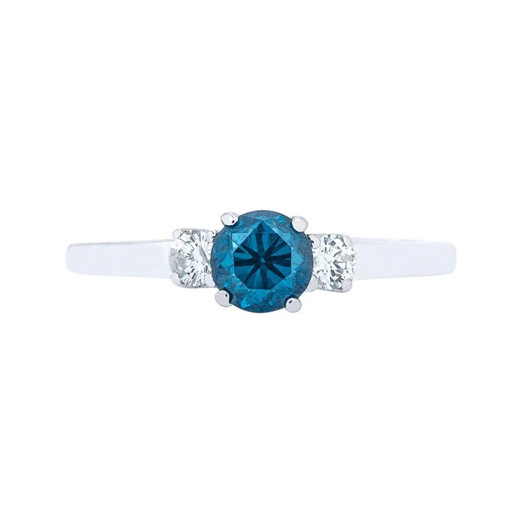 White gold three-stone engagement ring centered with a blue sapphire and diamond side stones.